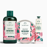 The Body Shop British Rose product set including shower gel, body butter, and hand cream on a white background.