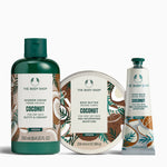 The Body Shop coconut skincare products including shower cream, body butter, and hand balm on a white background.