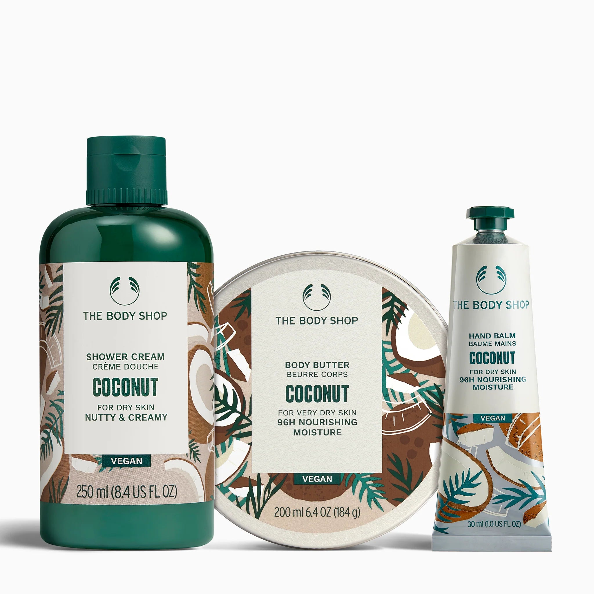 The Body Shop coconut skincare products including shower cream, body butter, and hand balm on a white background.