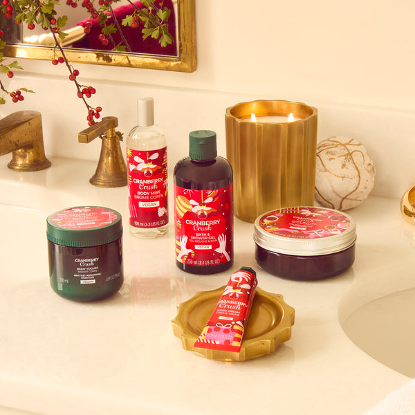Bathroom counter with various beauty products including bottles, jars, and a candle.