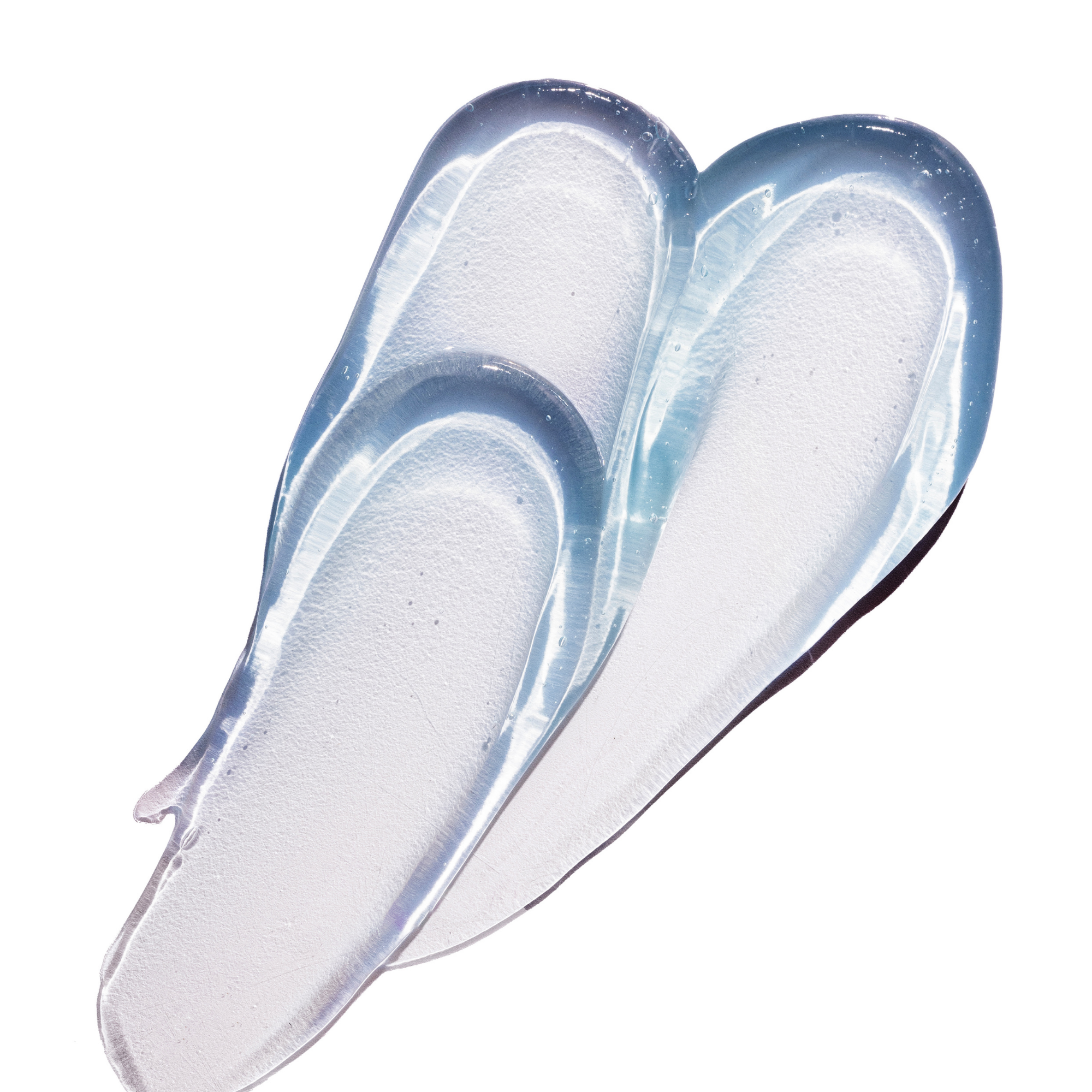 Two translucent, clear silicone or plastic inlay pieces with a glossy finish, arranged diagonally on a solid white background.