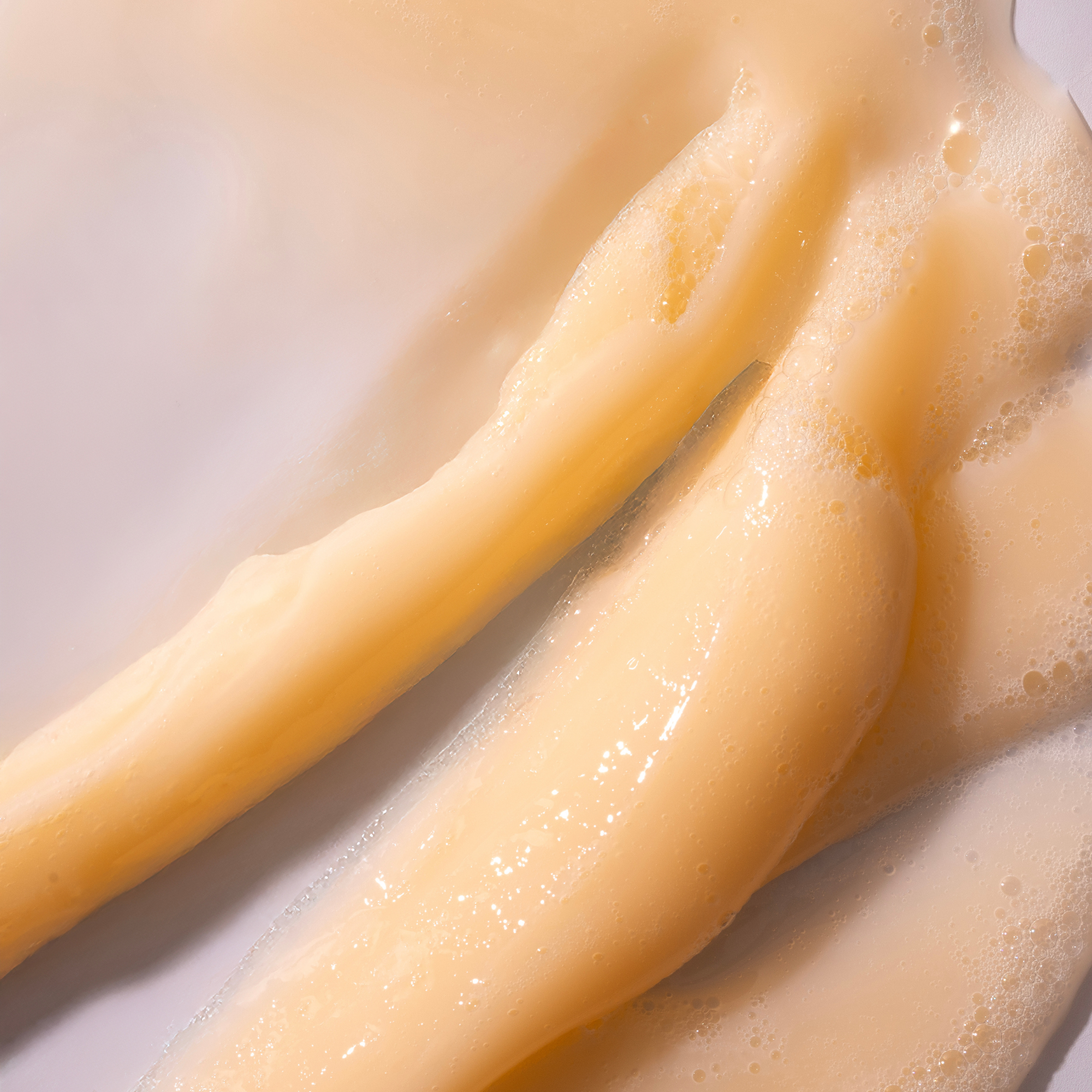 Close-up of legs with a beige color on a light background