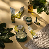 Collection of skincare products on a beige surface with green leaves.