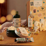 The Body Shop products including shower cream, body butter, and bath salts on a wooden surface with a blurred background.