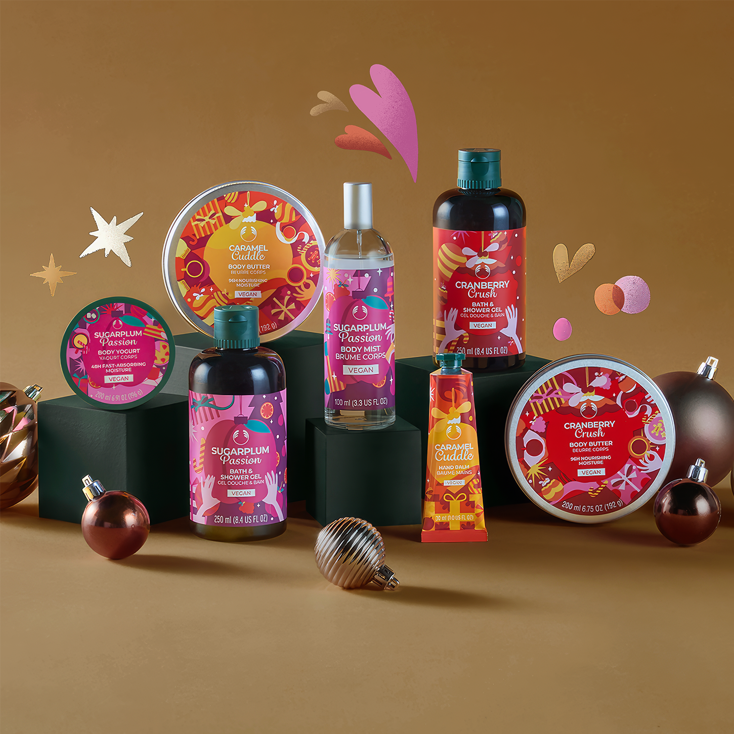 Collection of holiday-themed body care products on a brown background with decorative elements.