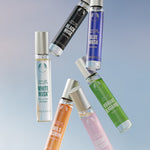 Collection of various perfume bottles on a gradient background