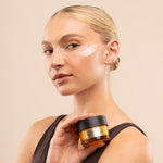 Woman holding a jar of skincare product with a beige background