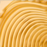 Close-up of smooth, yellow cream with concentric circles.