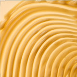 Close-up of smooth, yellow cream with concentric circles.
