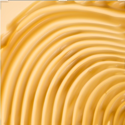 Close-up of smooth, yellow cream with concentric circles.