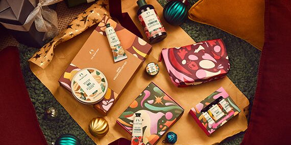 Collection of decorative items including a small bag, bottles, and boxes on a textured surface.