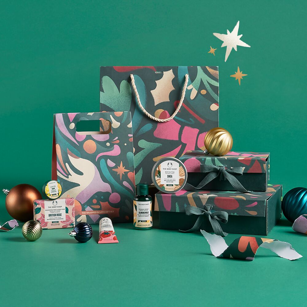 Decorative gift bags and items on a green background with festive elements.