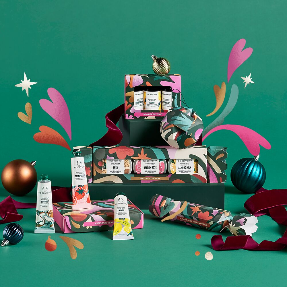 Colorful holiday gift set with decorative elements on a green background