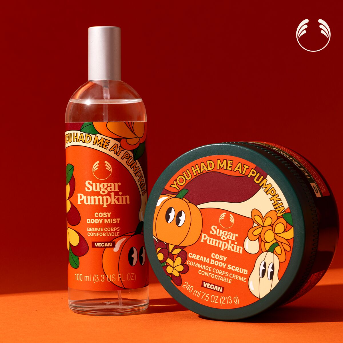 Sugar Pumpkin body mist and scrub on a red and orange gradient background
