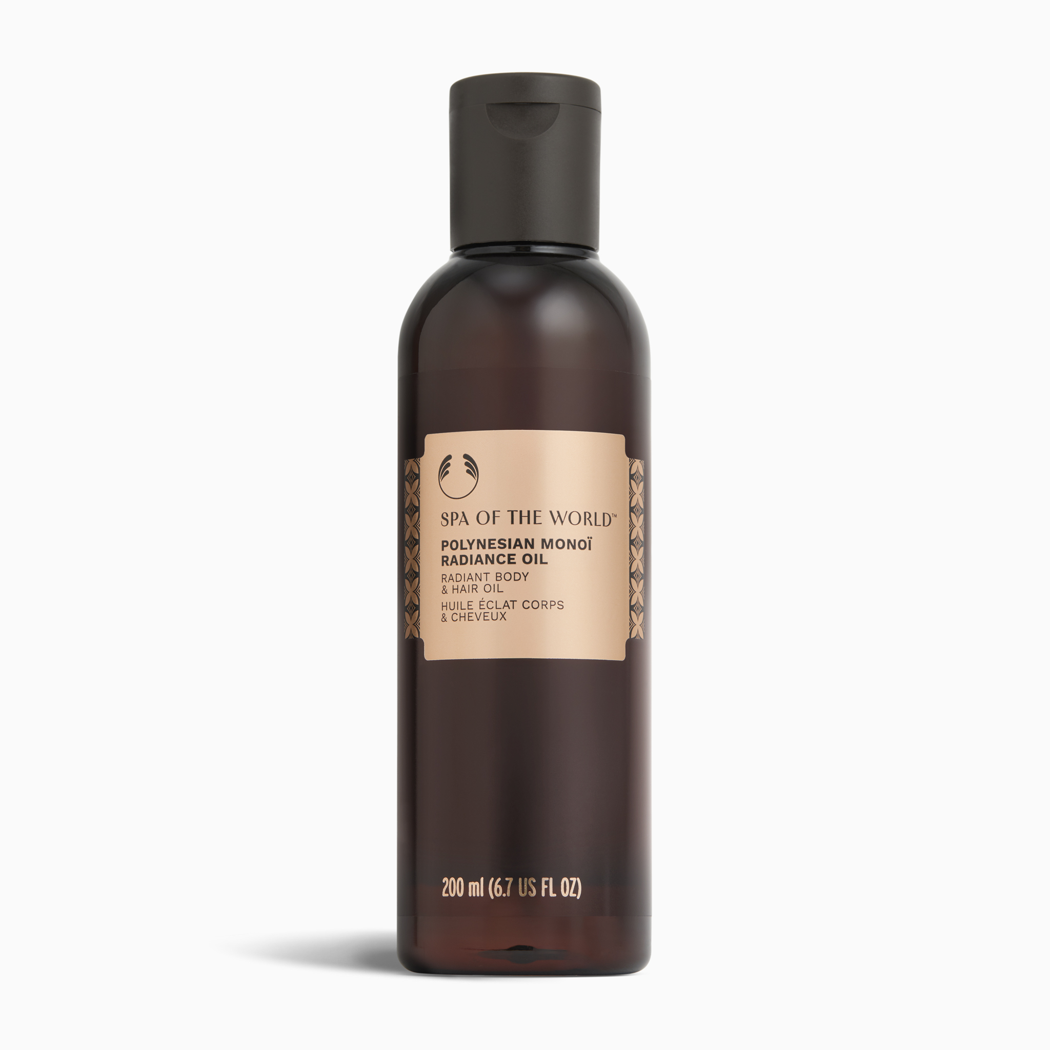 Brown bottle with a  rose gold label for The Body Shop SPA OF THE WORLD product titled Polynesian monoi radiance oil
