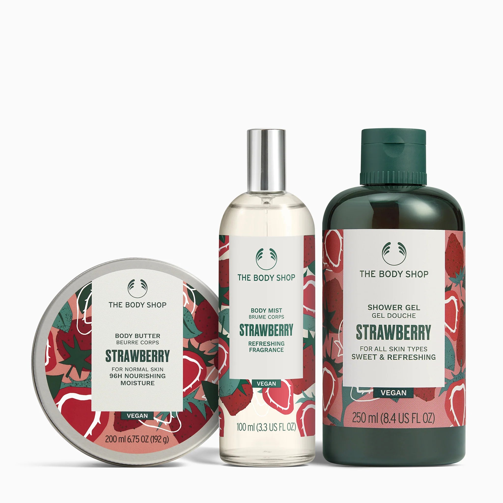 The Body Shop Strawberry products including the body butter, body mist and shower gel on a white background