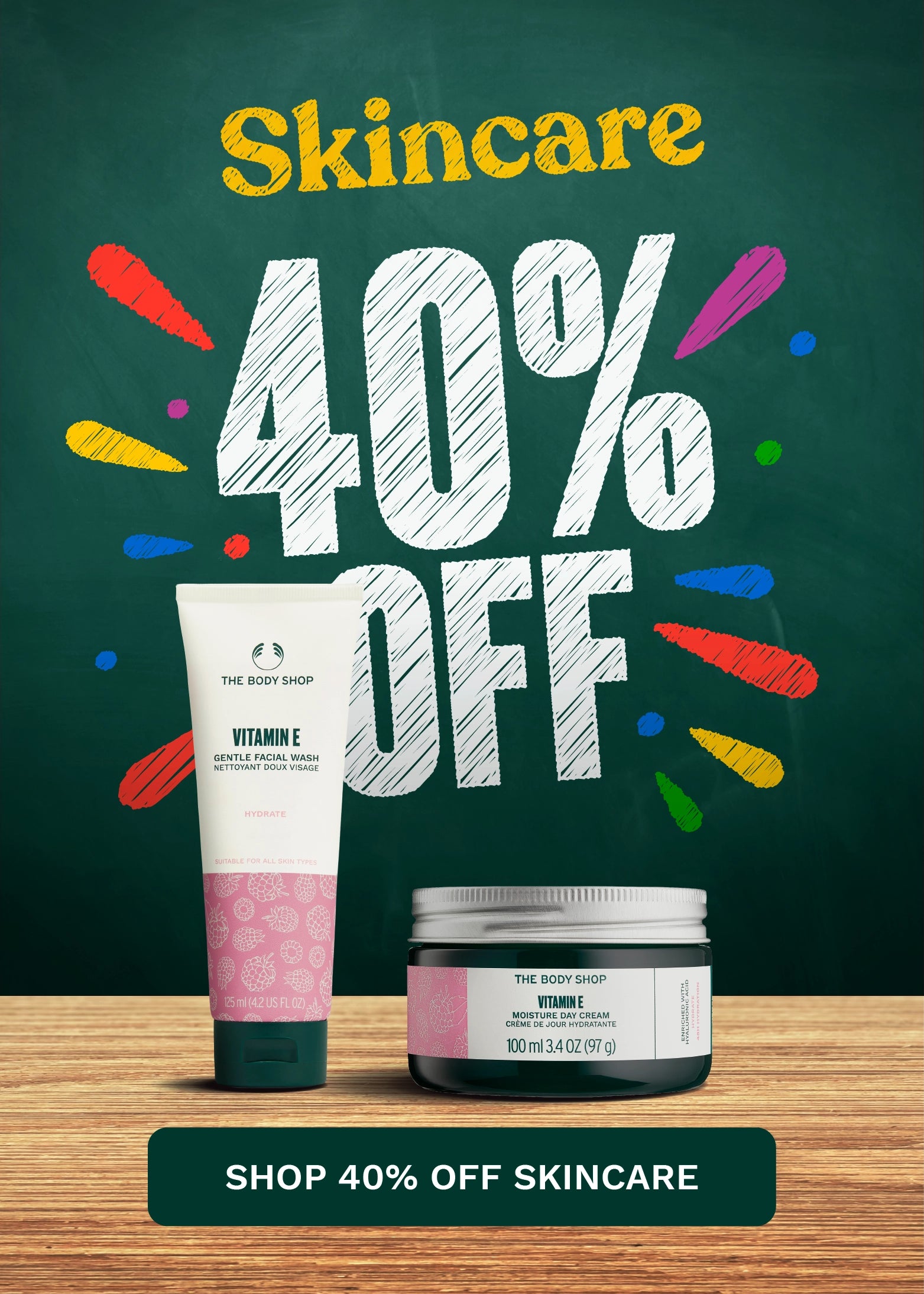 Promotional skincare banner featuring a white and pink tube and a dark jar from The Body Shop on a wooden surface against a dark green chalkboard-style background with large text reading 'Skincare 40% OFF' and a 'SHOP 40% OFF SKINCARE' button at the bottom.