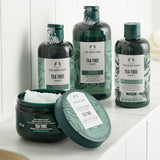 The Body Shop Tea Tree hair care products on a white surface