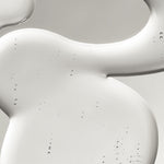 Close-up of a clear liquid, textured surface with a smooth, curved edge.