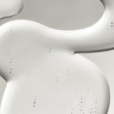 Close-up of a clear liquid, textured surface with a smooth, curved edge.