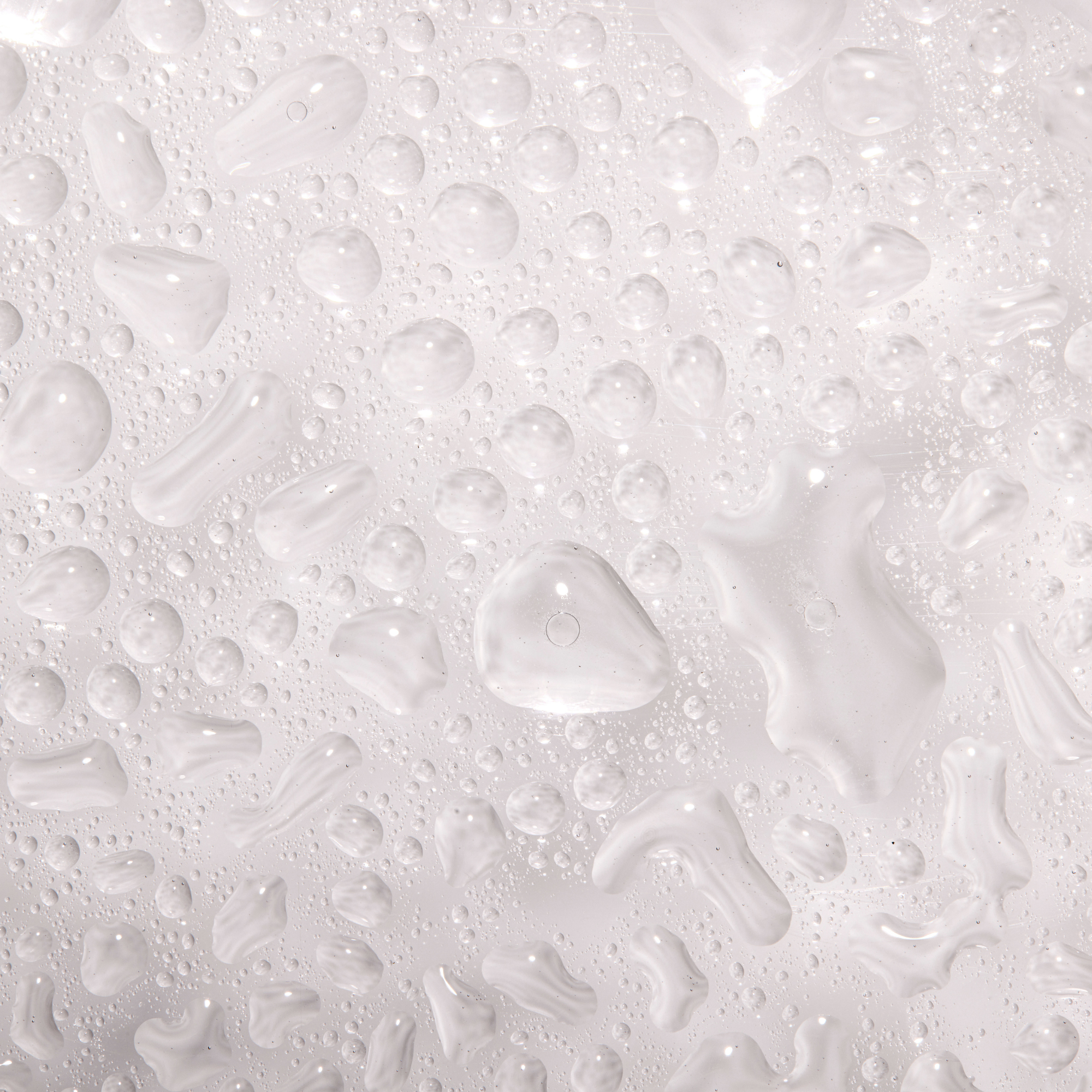 Textured white surface with water droplets and patterns