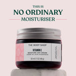 Jar of The Body Shop Vitamin E Moisture Day Cream on a light pink background with text 'This is No Ordinary Moisturiser'.