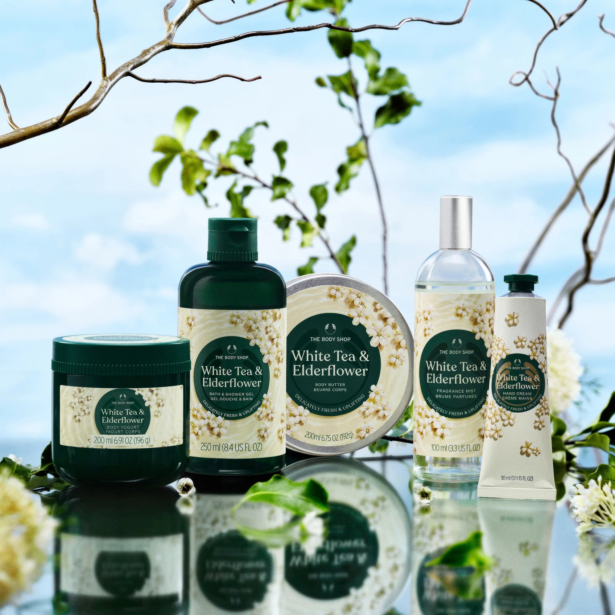 Collection of 'White Tea & Elderflower' skincare products with natural background