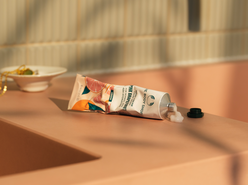 Tube of hand cream on a bathroom counter with a blurred background