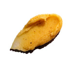 Close up of a orange coloured scrub on a white background