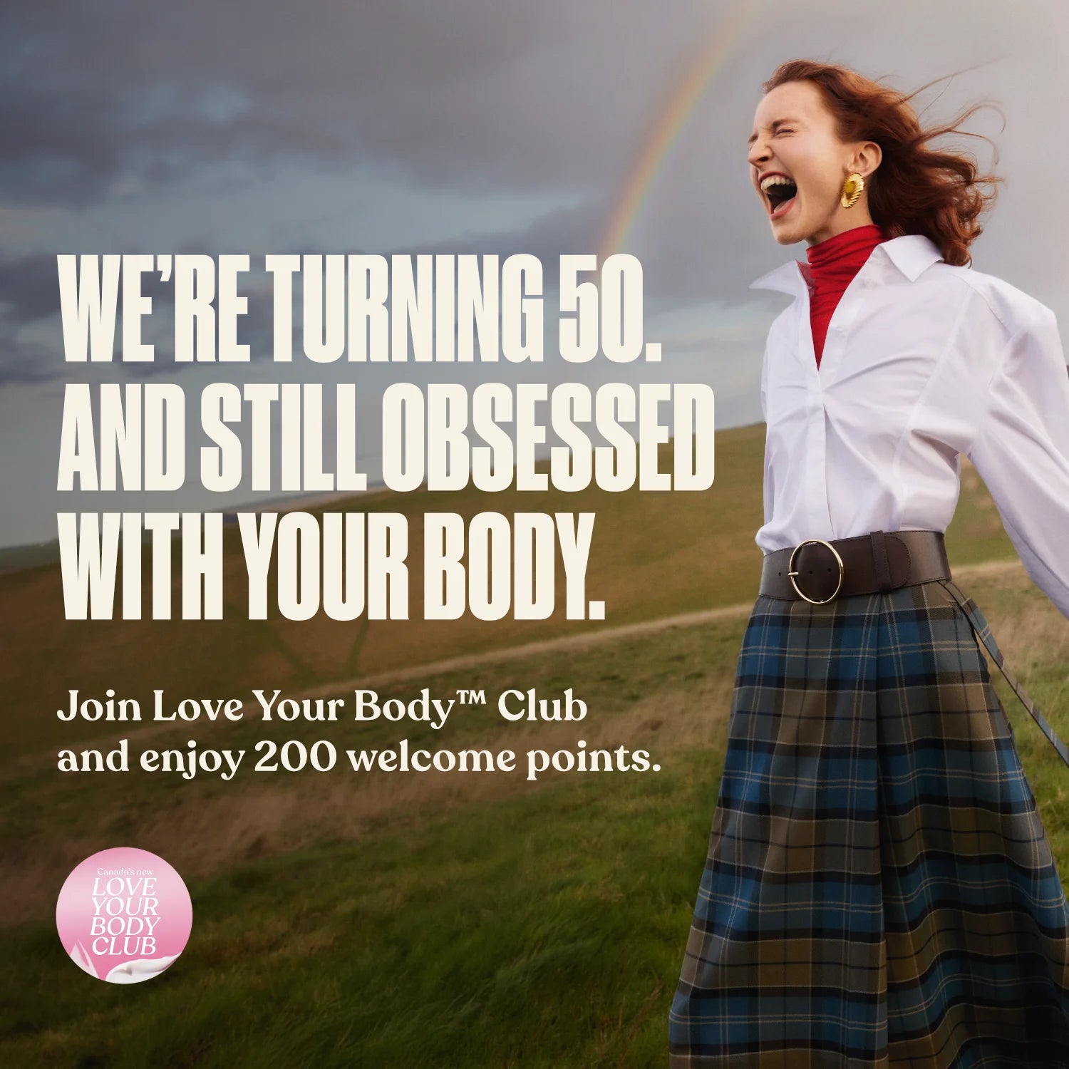Woman in a plaid skirt and white shirt standing in a field with a rainbow, text about turning 50 and joining the love your body club