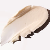 Close-up of a swatch of beige cream on a white background