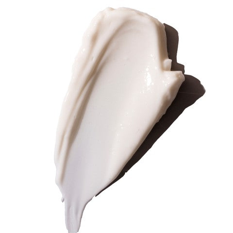 Close-up of a swatch of white cream on a white background