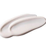 Swatch of a white coloured cream on a white background