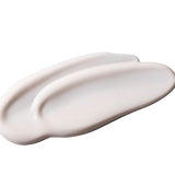 Swatch of a white coloured cream on a white background