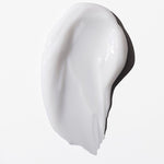 Swatch of a white cream on a white background