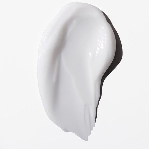 Swatch of a white cream on a white background